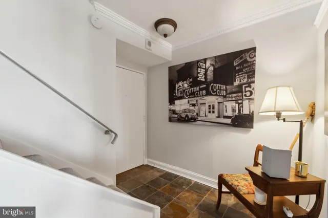 a living room with furniture and a painting