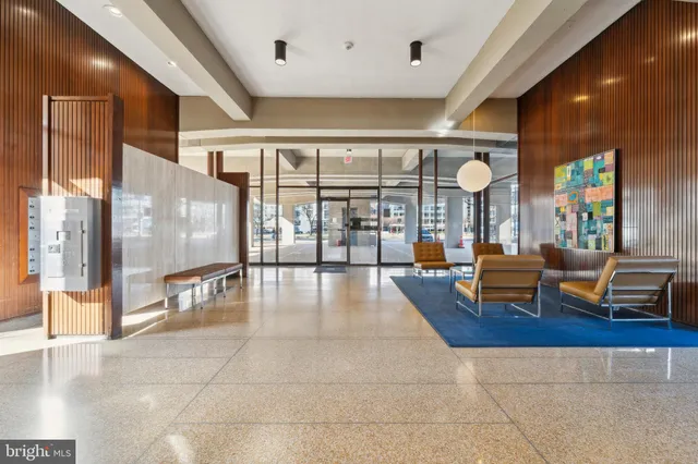 a lobby with furniture and large windows