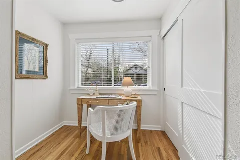 a dining room with wooden floor and a window