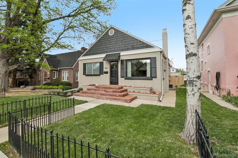 a front view of a house with backyard and sitting area