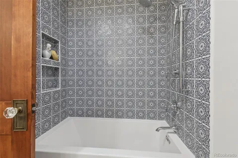 a bath tub sitting next to a white sink