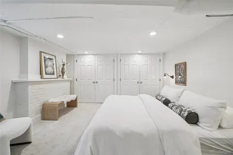 a spacious bedroom with a bed and a couch