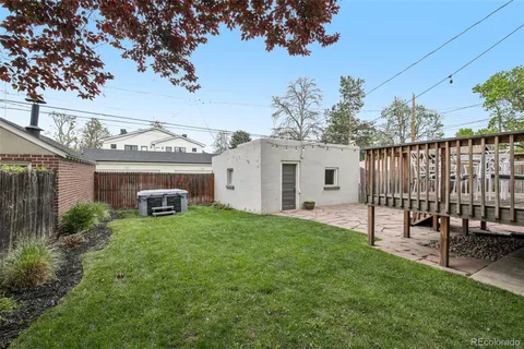 a view of a house with backyard and sitting area