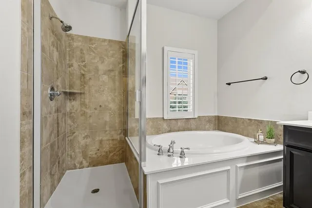 a large bathroom with a sink a large mirror and a bathtub