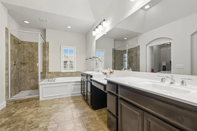 a bathroom with double vanity sinks and a mirror