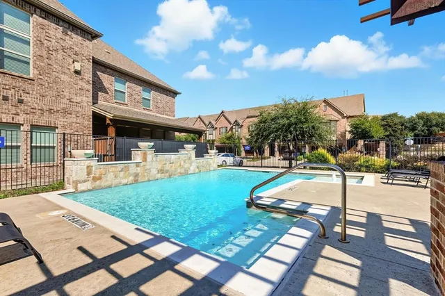 a view of a house with swimming pool and sitting area