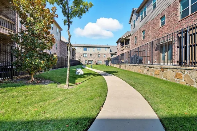 a view of a pathway of a building with a small yard