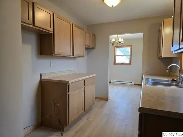 a utility room with cabinets washer and dryer