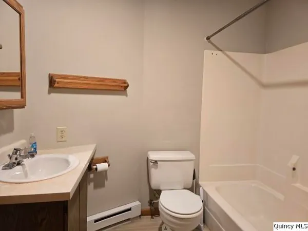 a white toilet sitting next to a bathroom sink