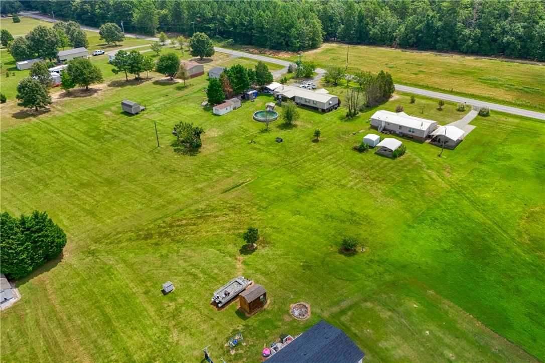1905 Bethany Church Road Belton, SC 29627 - Photo 20 of 20 Expansive green acreage surrounds rural structures, offering plenty of open space and privacy.