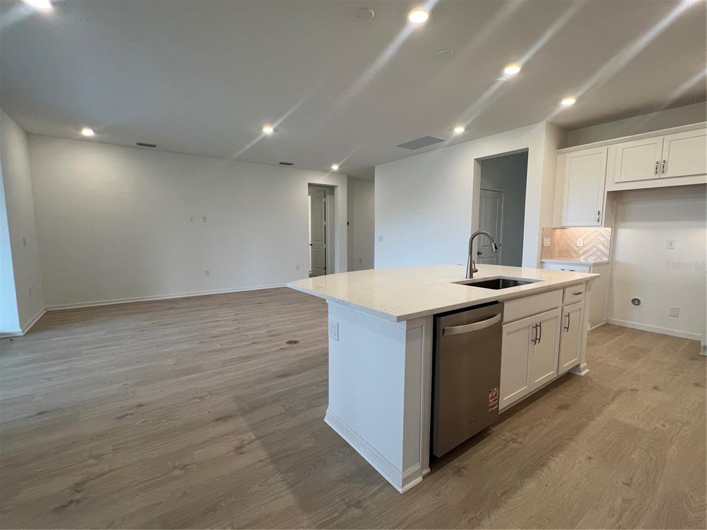 2075 Keystone Pass Boulevard Minneola, FL 34715 - Photo 13 of 27 a kitchen with a sink and wooden floor