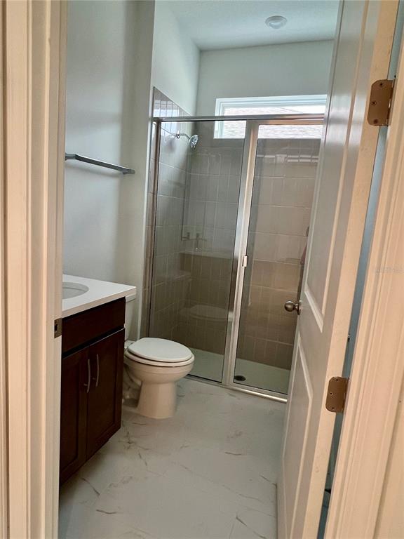 2075 Keystone Pass Boulevard Minneola, FL 34715 - Photo 4 of 27 a bathroom with a toilet a sink and a shower