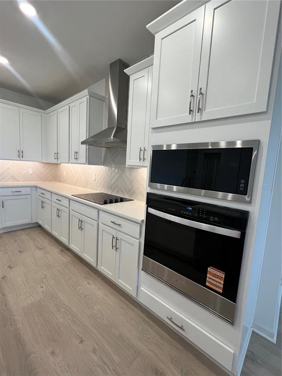 2075 Keystone Pass Boulevard Minneola, FL 34715 - Photo 8 of 27 a kitchen with granite countertop white cabinets and appliances