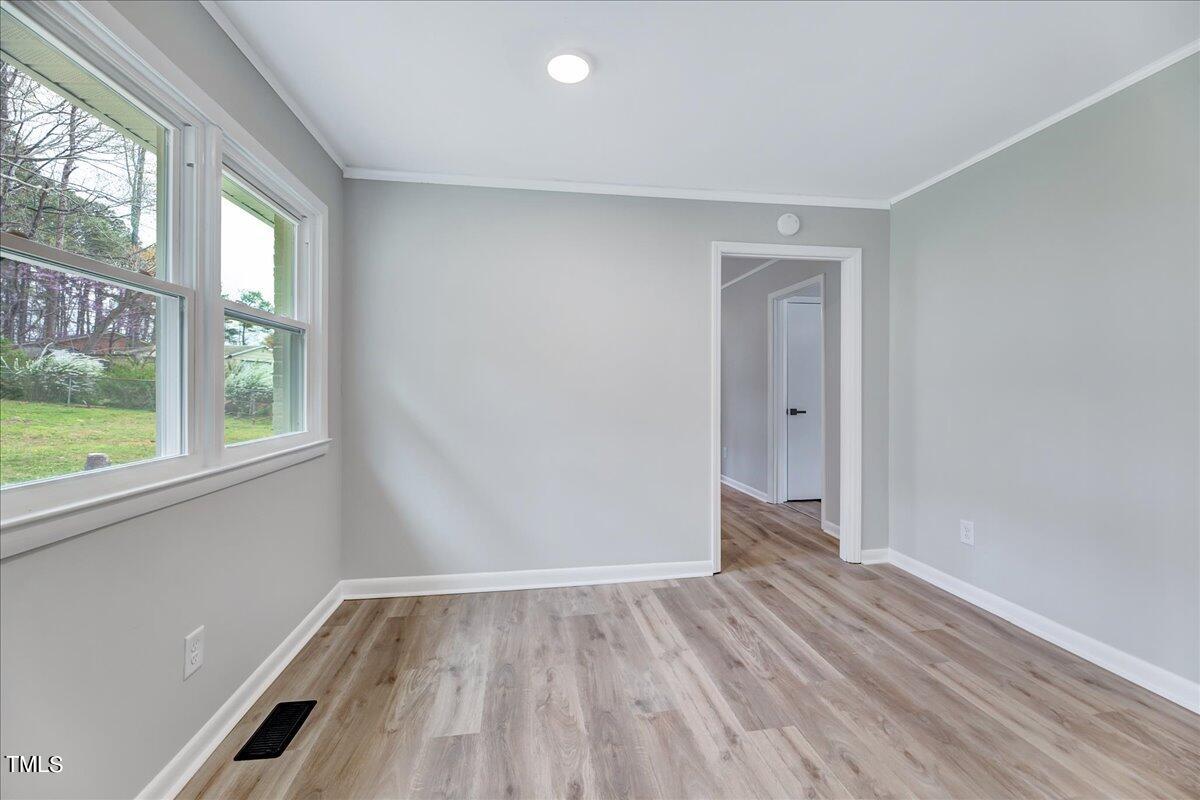 2808 Oak Ridge Court Raleigh, NC 27603 - Photo 17 of 43 an empty room with wooden floor and windows