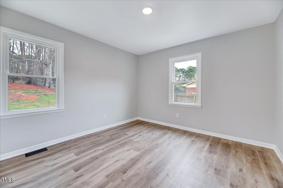 2808 Oak Ridge Court Raleigh, NC 27603 - Photo 23 of 43 a view of room with window and wooden floor