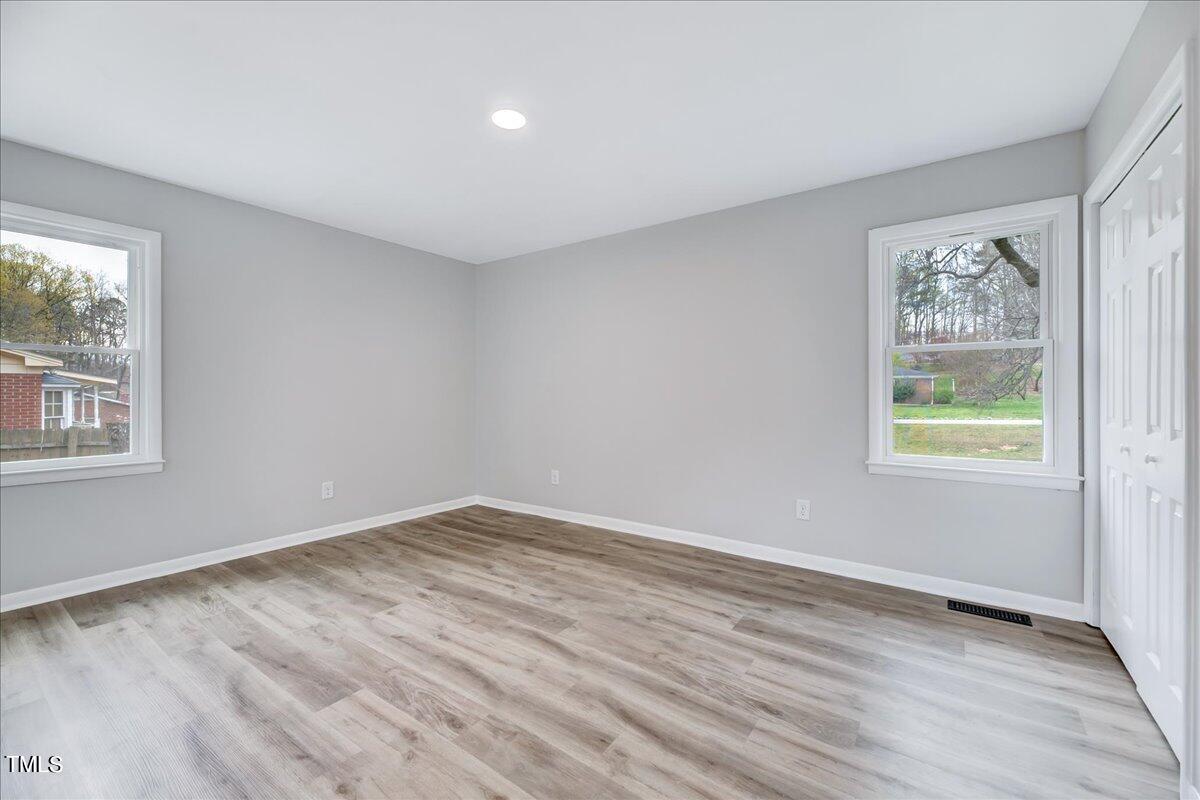 2808 Oak Ridge Court Raleigh, NC 27603 - Photo 26 of 43 a view of an empty room with wooden floor and a window