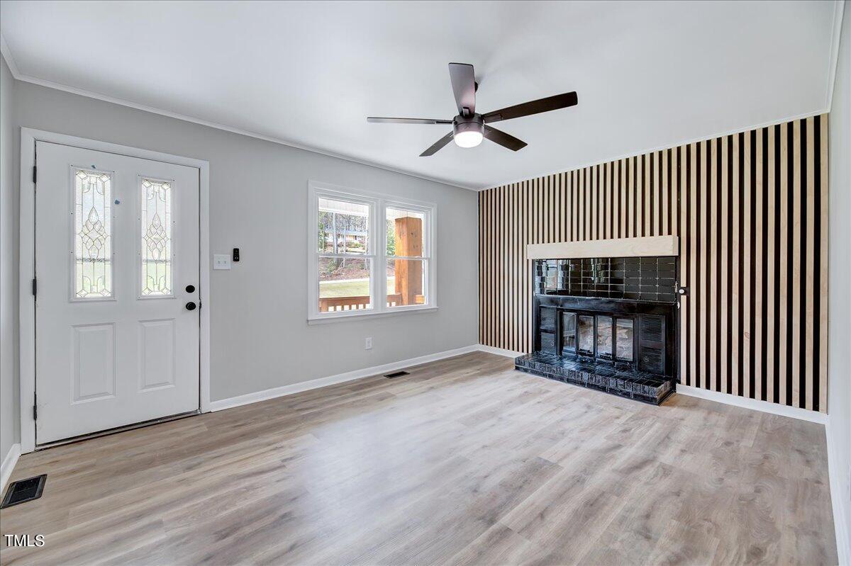 2808 Oak Ridge Court Raleigh, NC 27603 - Photo 9 of 43 a view of an empty room with glass door and wooden floor