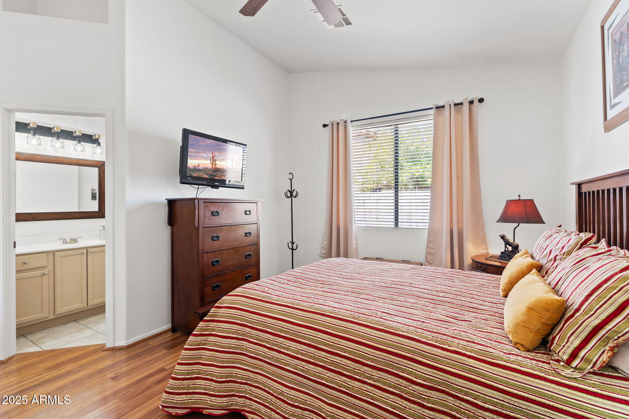 4169 East Hallihan Drive Cave Creek, AZ 85331 - Photo 12 of 13 a bedroom with a bed and wooden floor