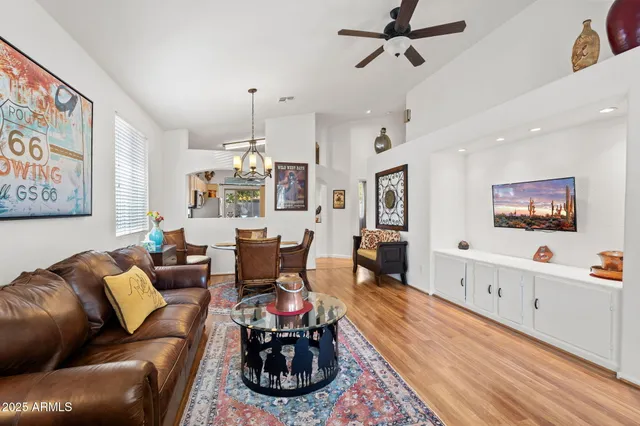 a living room with furniture and a chandelier