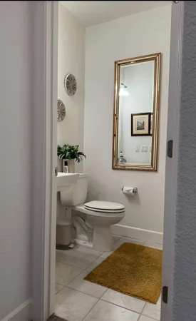 a bathroom with a toilet a sink and mirror