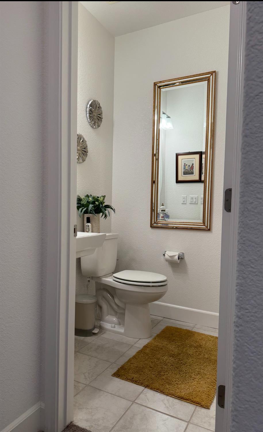 461 Walcott Street Manteca, CA 95336 - Photo 14 of 24 a bathroom with a toilet a sink and mirror