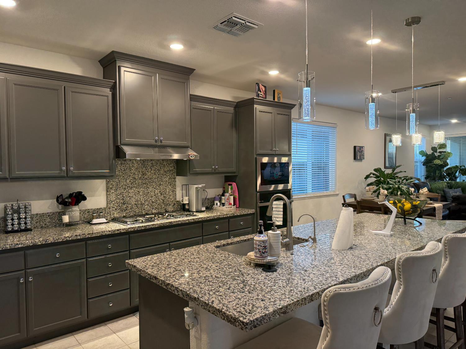 461 Walcott Street Manteca, CA 95336 - Photo 2 of 24 a kitchen with center island a sink stainless steel appliances and cabinets