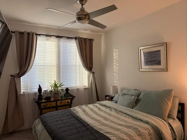 a bedroom with a bed and wooden floor