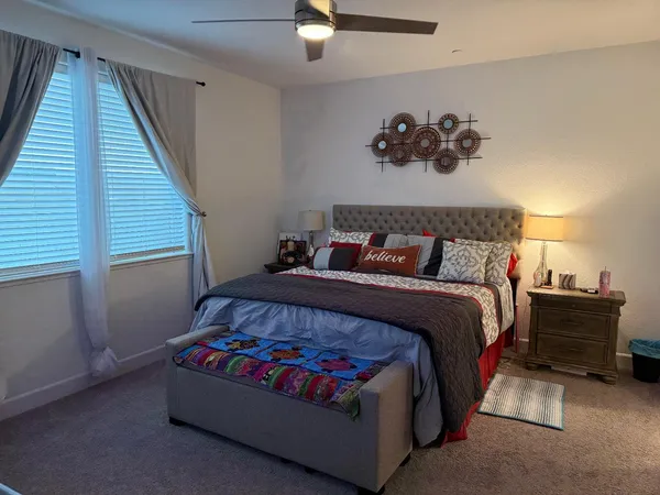 a bedroom with a bed and window