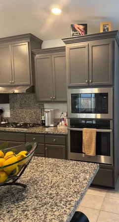 a kitchen with stainless steel appliances granite countertop a stove a sink and a microwave