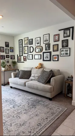 a living room with furniture and painting on the wall