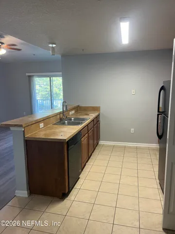 a kitchen with a sink a counter top space and a window