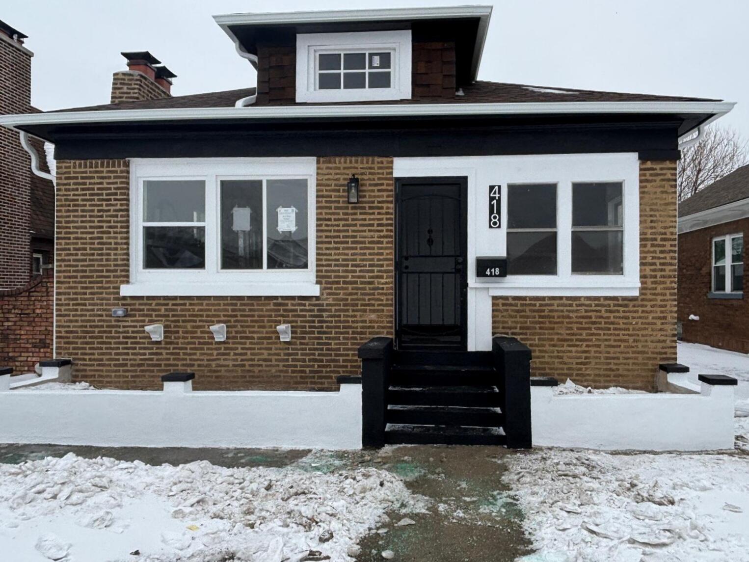 a front view of a house with a wooden bench