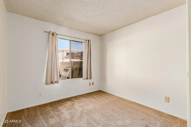 a view of a hallway with closet and bathroom