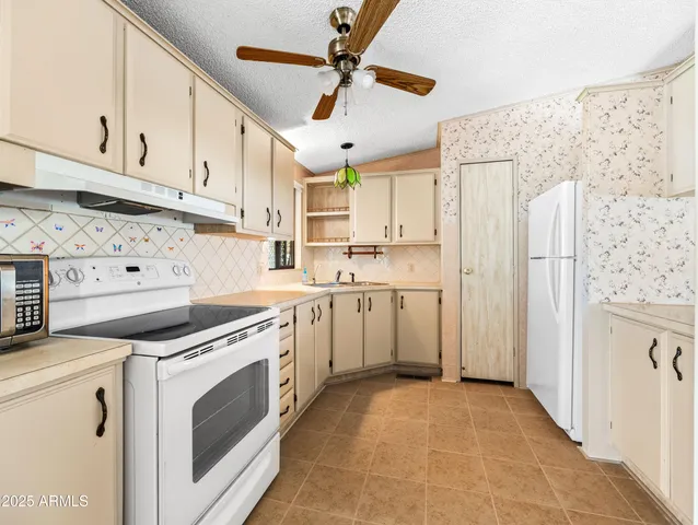 a view of a kitchen with electric appliances
