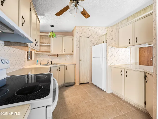 a kitchen with a stove a sink and a refrigerator