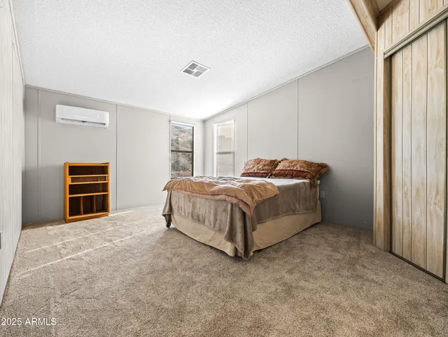 a bedroom with a bed and a closet