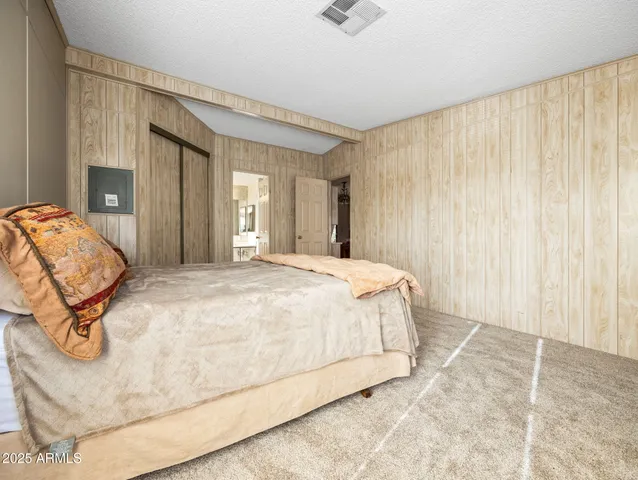 a spacious bedroom with a bed and a window