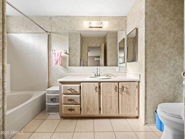 a bathroom with a sink a mirror and a bathtub