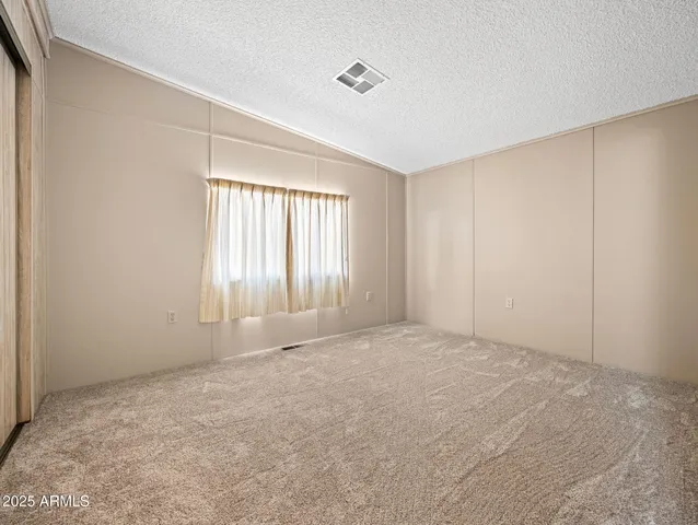 a view of an empty room with windows