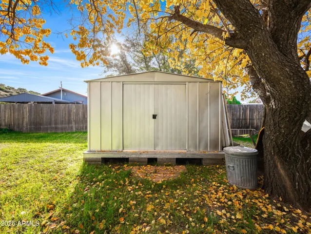 a view of a back yard with wooden fence