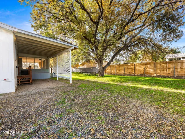 a view of a house with a backyard
