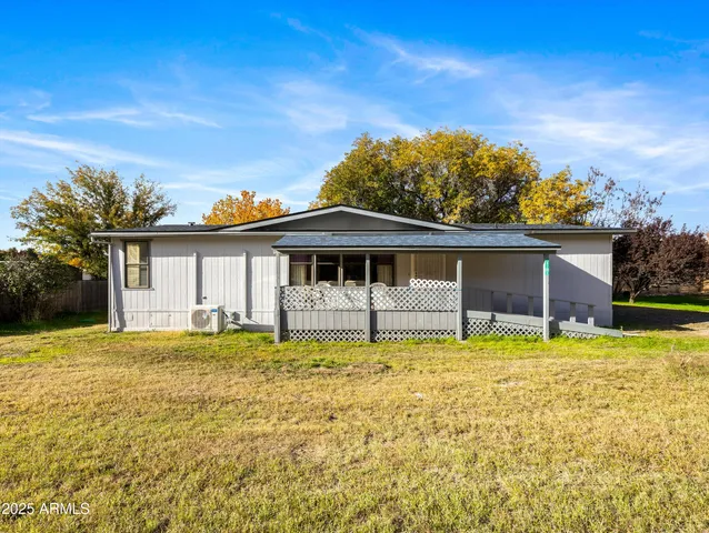 a front view of a house with a garden and yard