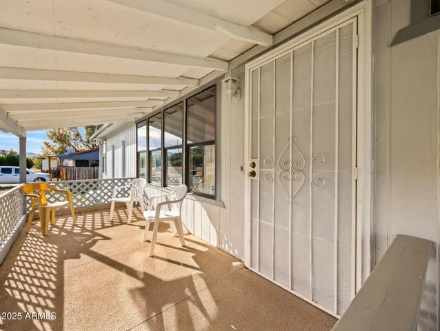 a view of a room with furniture and white walls