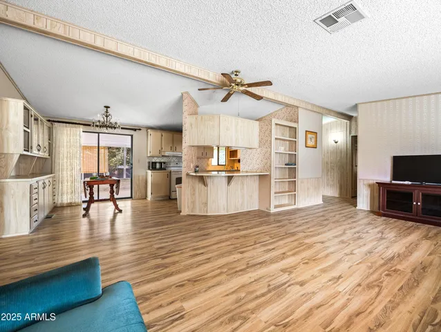 a view of a living room kitchen and a wooden floor