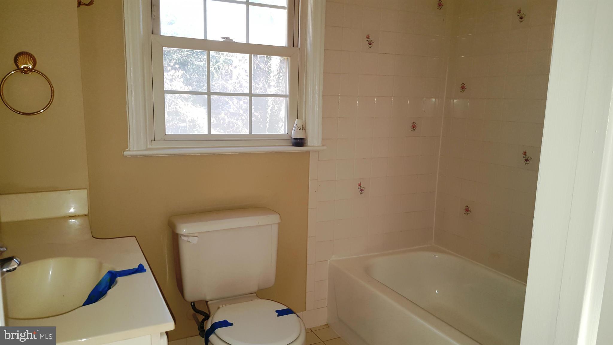 9011 Eton Road Silver Spring, MD 20901 - Photo 9 of 13 a bathroom with a sink and a toilet