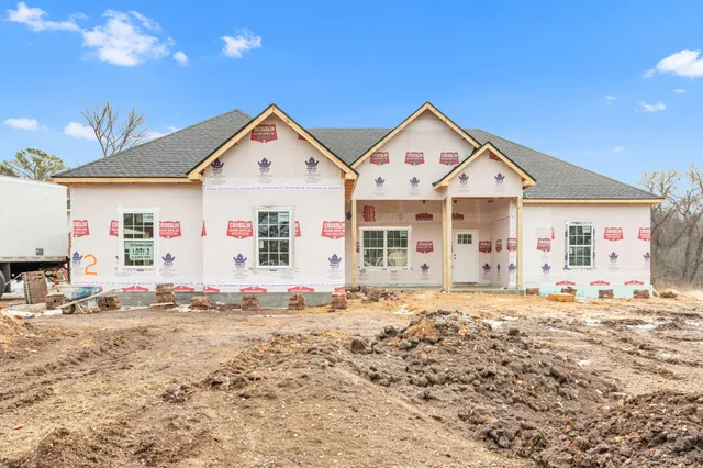 a aerial view of a house with a stone wall