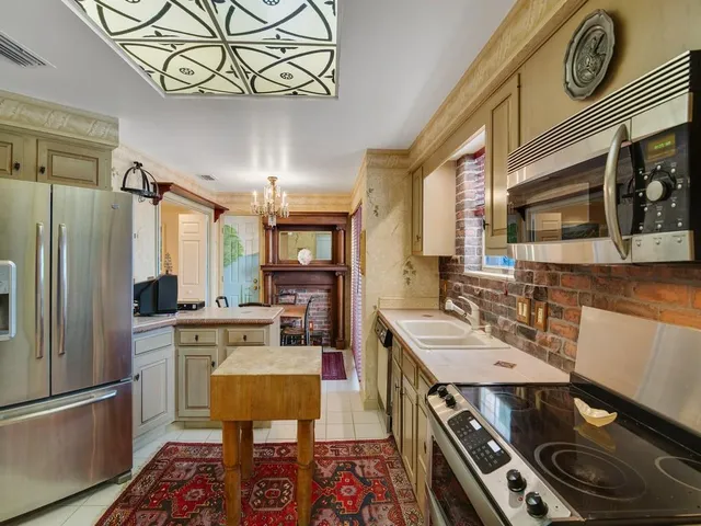 a kitchen with a stove a refrigerator and a dining table