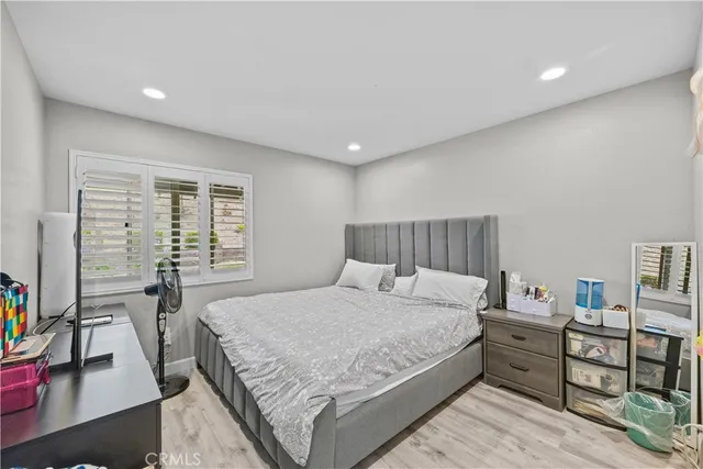 a bedroom with a bed and a desk in it