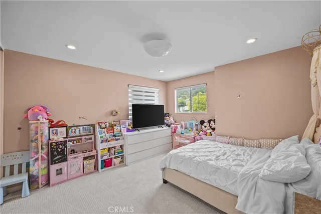 a bedroom with furniture and a flat screen tv