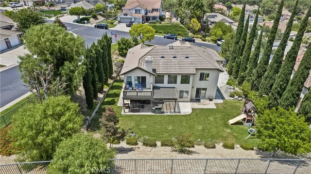 an aerial view of a house with swimming pool and garden view